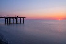 Sunset and pier in the sea