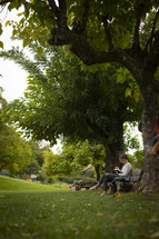 Woman reading on a bench in a park