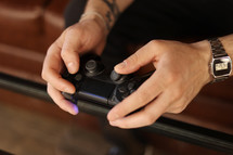 Playing games concept. Part body man with joystick play game on console. Male hands holding pad. High quality photo.