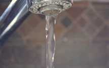 Water running out of a faucet.