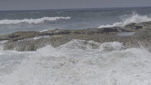 Ocean waves crashing against a rocky shore.