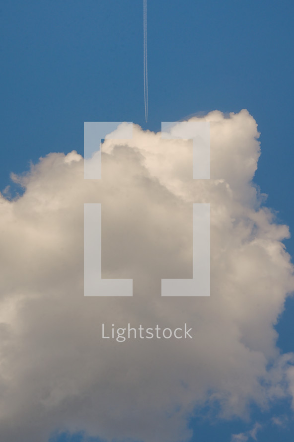 Conceptual Plane flying among white fluffy clouds 