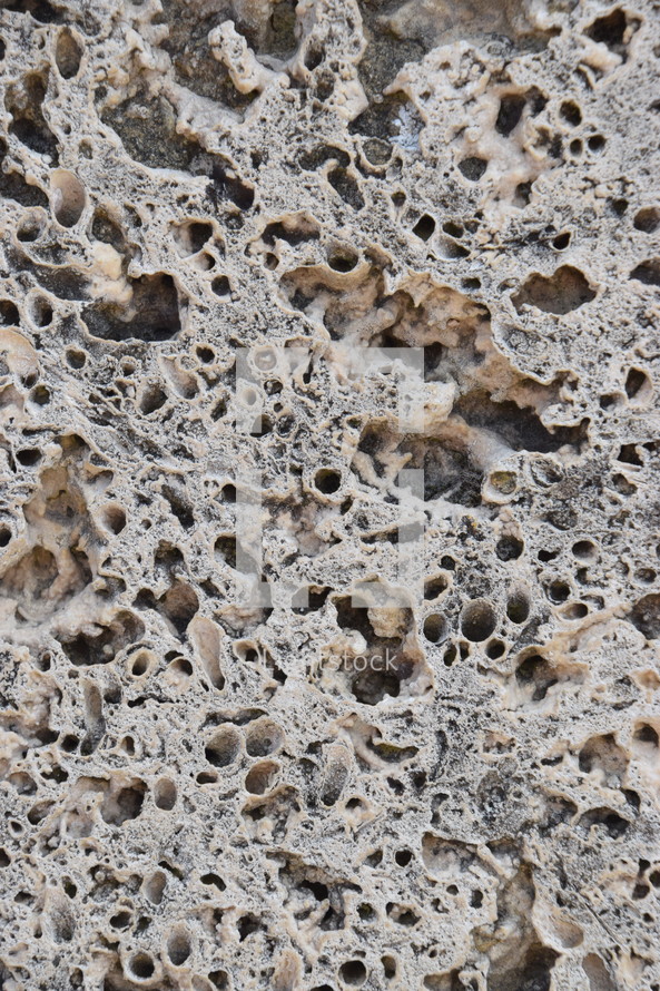 natural porous stone surface with holes as neutral background