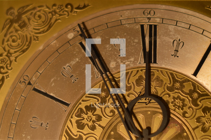 five minutes before twelve o'clock at a ancient golden clock.  
late, last minute, scarce, high time, waste, wasting, New Year, clock, watch, year, new, New Year's Day, come, coming, go, going, gone, fading, fleeting, ephemeral, evanescent, time, sliding, fade, slide, New Year's Eve, eve, future, past,  period, era, age, aging, temporary, present, moment, currently, view, prospect, outlook, perspective, vista, lookout, forecast, sluice, briefly, brief, momentary, short-duration, short-period, short-term, short-time, day, date, number, numeral, index, annual, annually, yearly, turn, turn of the year, gold, golden, change, changed, changing, season, seasons, vanish, pass, timepiece, timekeeper, horologe, timepieces, hour, minute, second, hours, minutes, seconds, ticking, tick, chronometry, timing, timer, timers, clockhand, hand, pointers, clock-hand, big hand, little hand, minute hand,  round, circular, circle, circles, orbital, old, ancient, antique