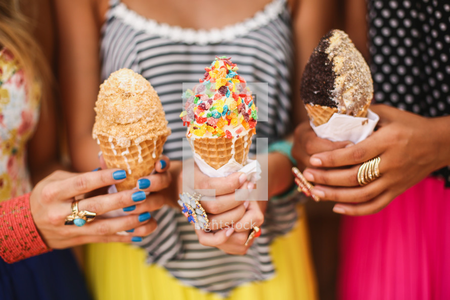 friends holding ice cream cones 