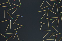 scattered matches on a black background 
