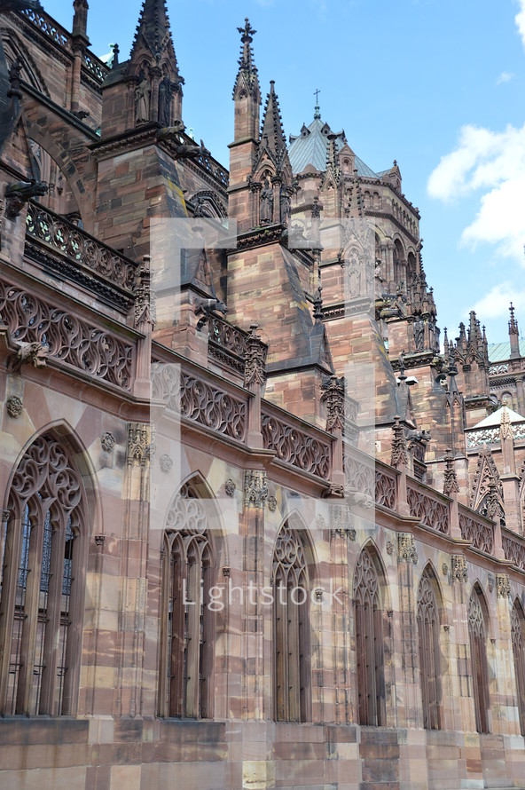 Details of a Gothic cathedral.
cathedral, old, Gothic, Gothic age, Gothic style, Gothic period, gothically, Europe, sandstone, freestone, brownstone, ogive, pointed arch, tower, exterior, church, roof, steeple, spire, high, copper roof, copper, flying buttresses, tall, slim, slender, gargoyle, waterspout, spout, figure, statues, jamb statues, sky, clouds