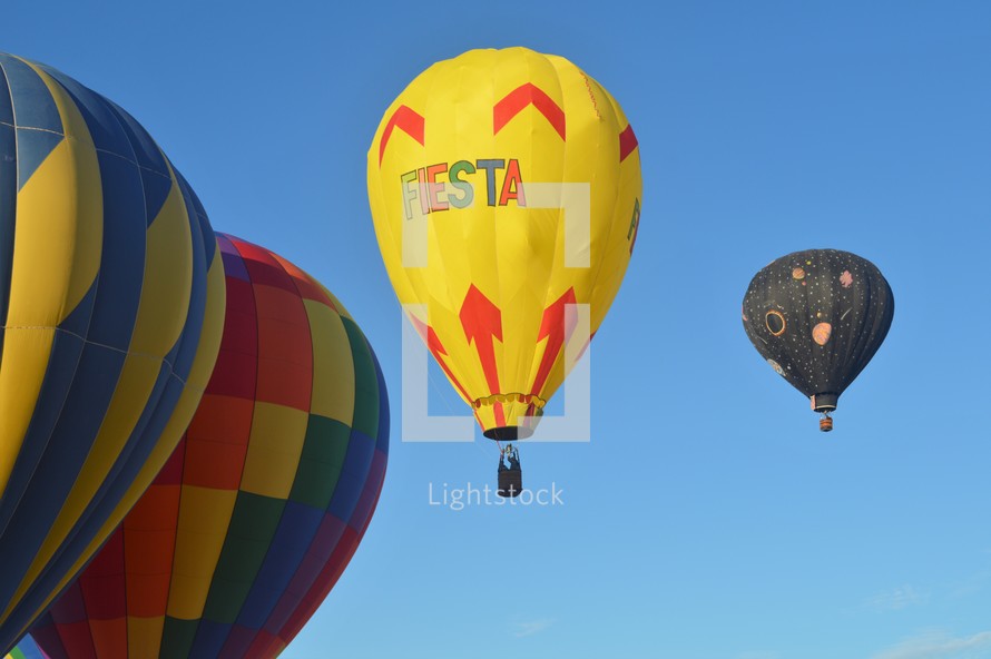 hot air balloons against a blue sky 