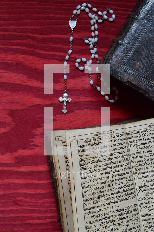 rosary beads and the pages of a Bible 