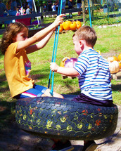 Kids playing on a tire swing