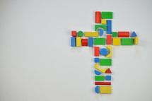 cross of colorful toy wooden blocks 