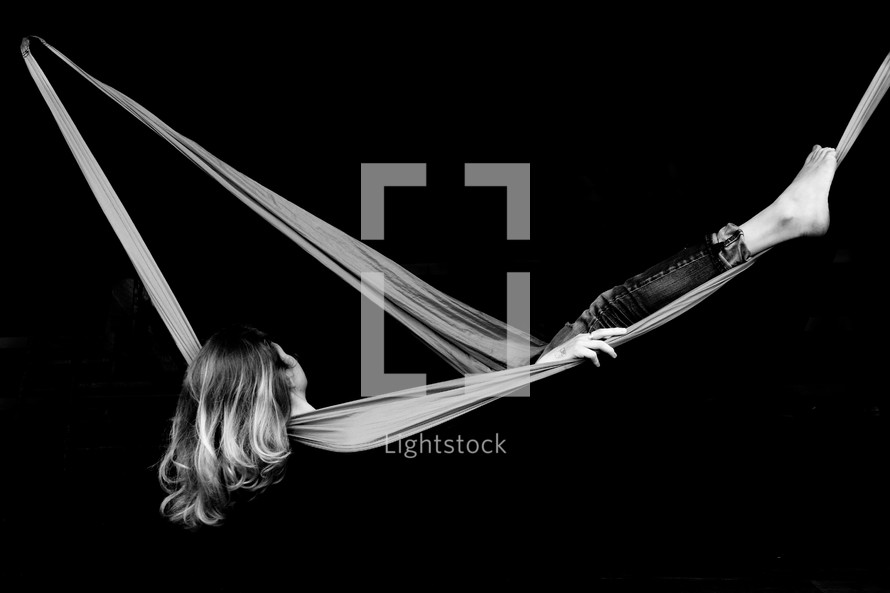 a woman in a hammock in studio 