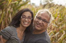 husband and wife in a corn field 