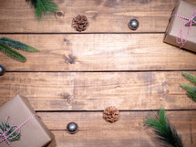 gifts and greenery on white wood boards 