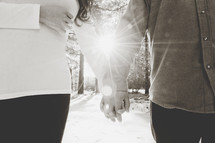 sunburst behind a couple holding hands