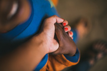 child and missionary holding hands 