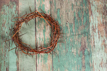 crown of thorns on a green wood background 