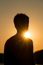 silhouette of a boy at sunset 