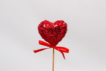 red glitter heart on a stick 
