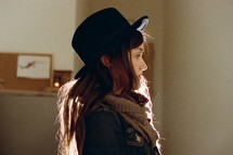 side profile of a woman in a hat 