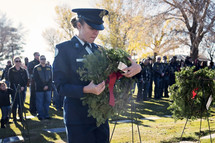 Solider with a wreath in a cemetery 