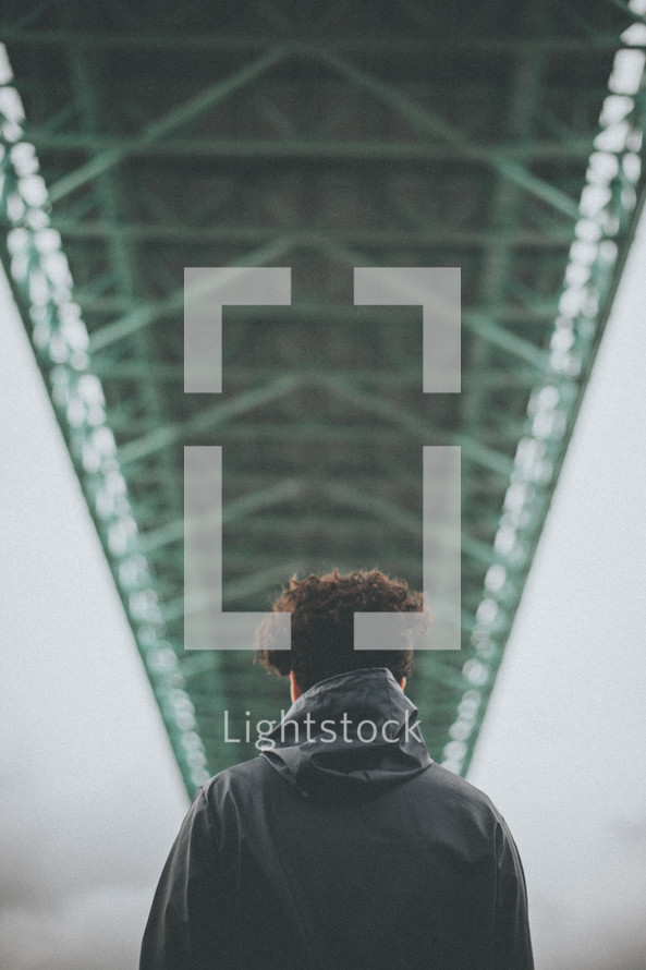 a man standing under a bridge 