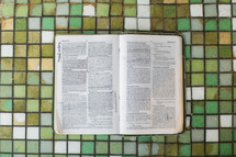 open Bible on tile 