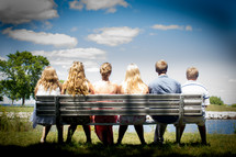 friends sitting on a park bench 