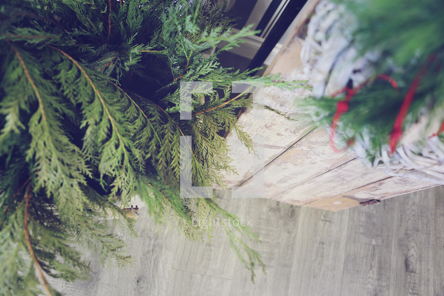 Christmas greens and wood floor