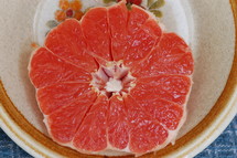 Half of a grapefruit on a plate.