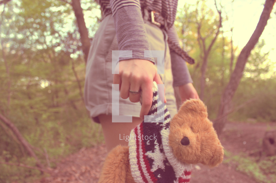 hand holding a teddy bear