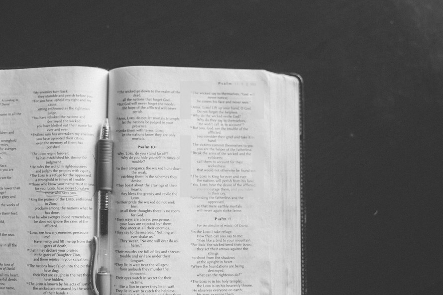pen in the pages of a Bible 