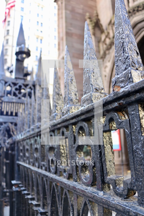 wrought iron fence in front of a church 