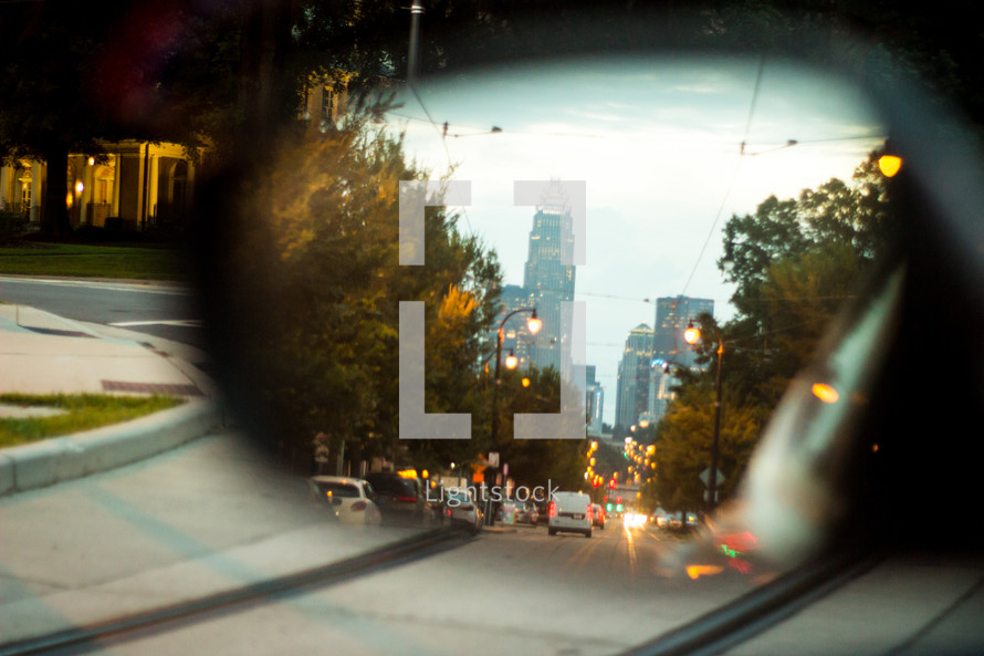 view of a city in a rearview mirror 