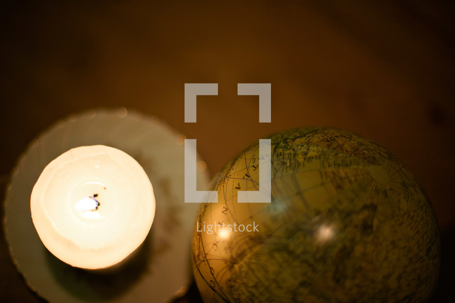 A candle and a globe. 