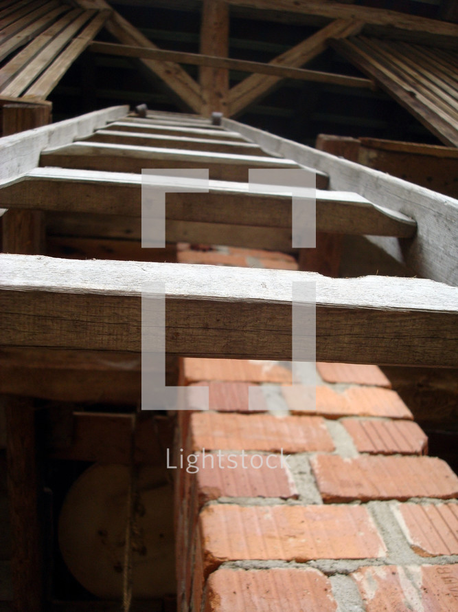 a ladder to the upper floor of a stable