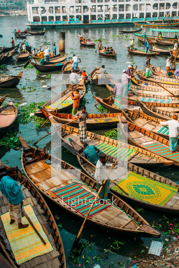 Boats with fishermen in Dhaka river in Bangladesh