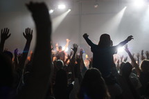 raised hands at a concert 