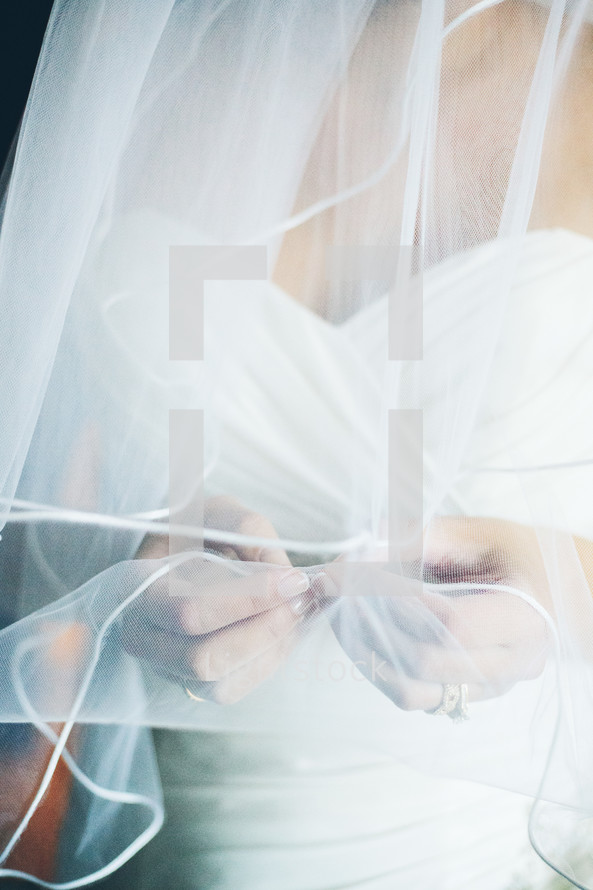bride touching her veil 