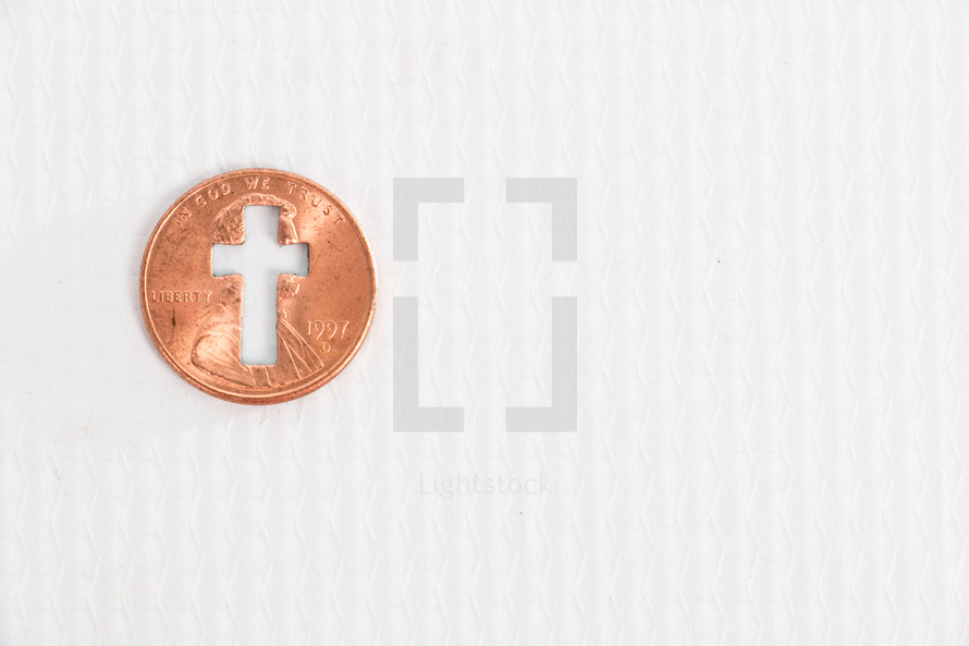 cross cutout in a penny 