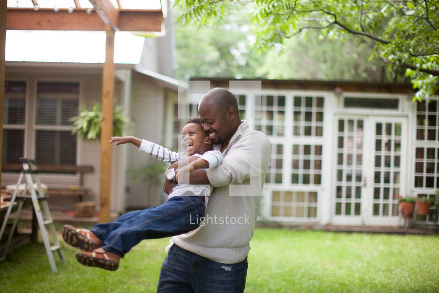 father and son hugging outdoors 