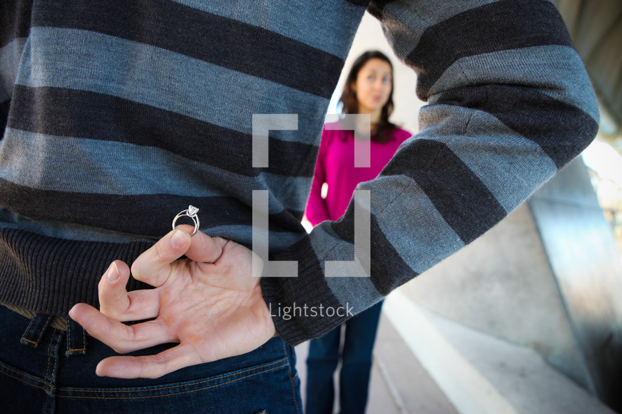 the proposal - man holding an engagement ring 