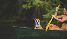 dog and woman in a row boat 