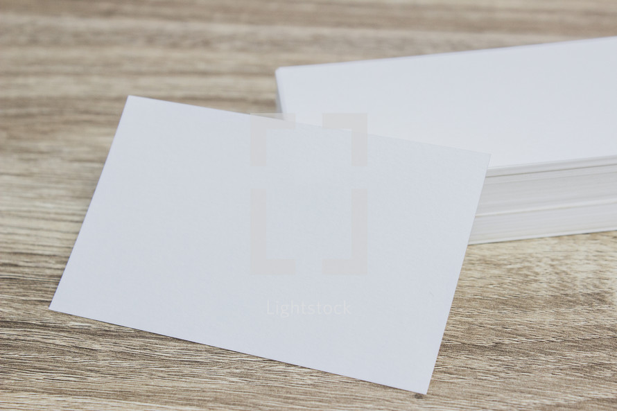 white notecards on a wood background 