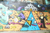 witch on a broom on a graffiti covered wall