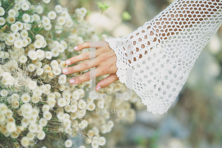 hands touching flowers 
