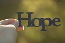 woman holding the word hope 