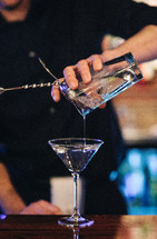 bartender pouring a cocktail 