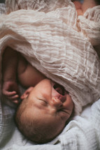 A baby lying in a swaddling clothes