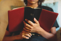 A young boy reading the BIble